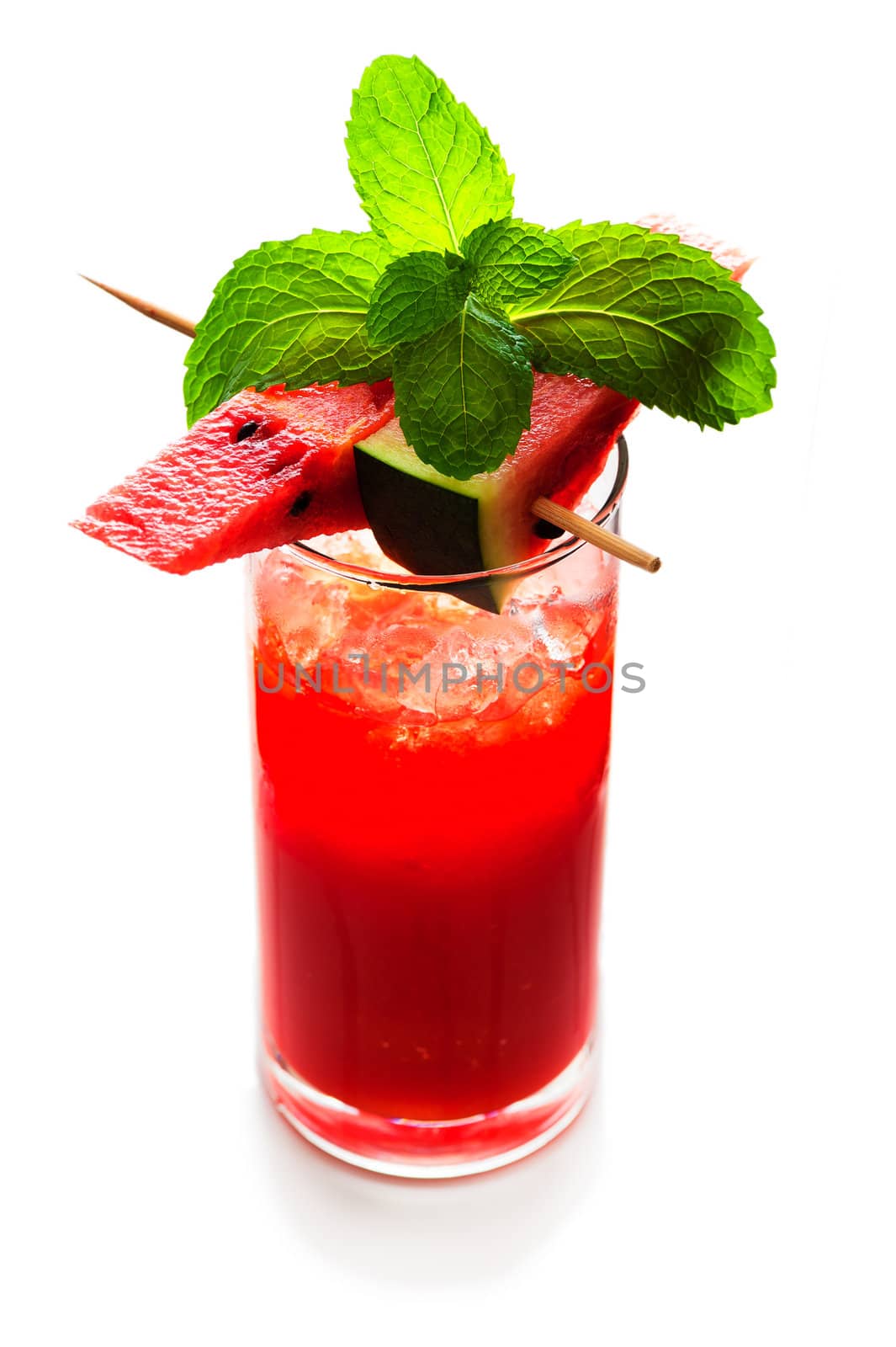 Watermelon smoothie garnished with watermelon slices and mint leaves isolated on white