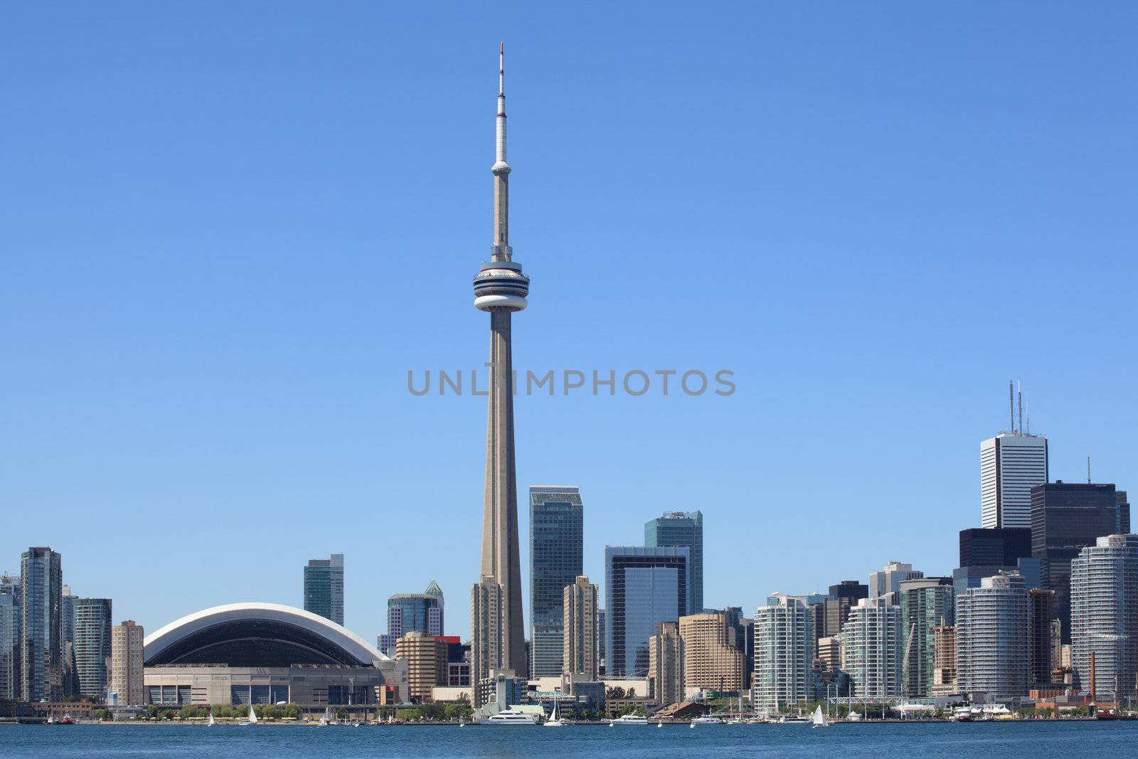 Photo of the Toronto skyline under a clear sky.