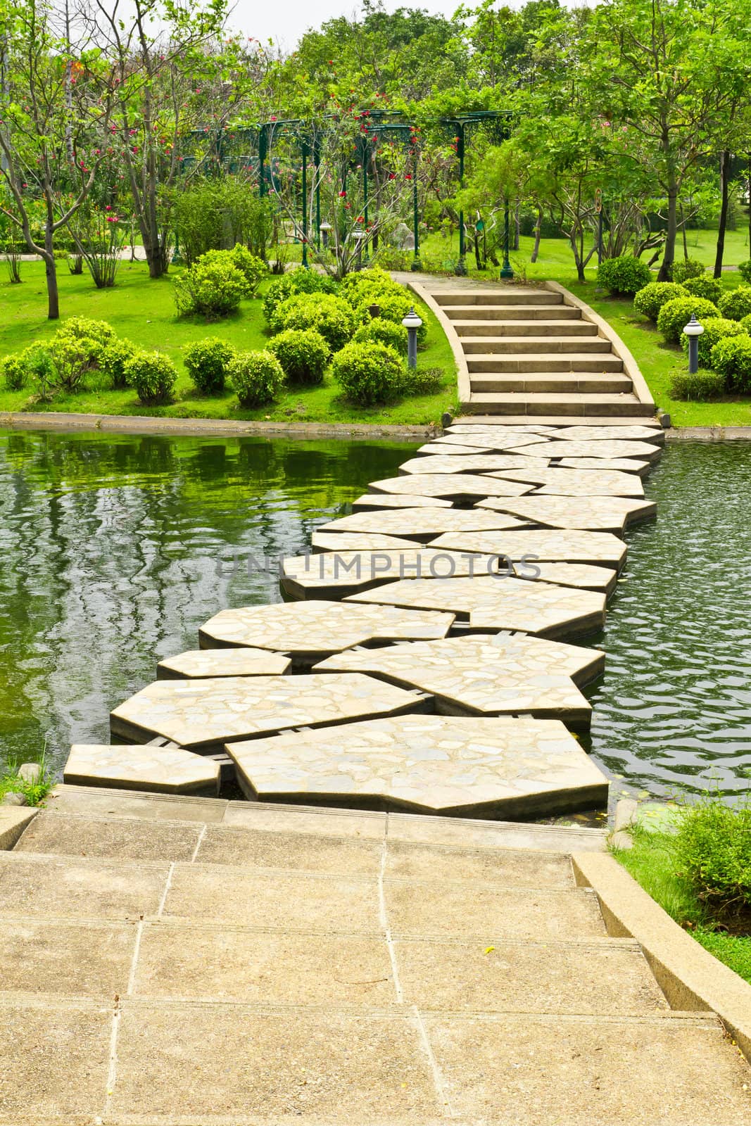 stone walkway on water in the park by tungphoto