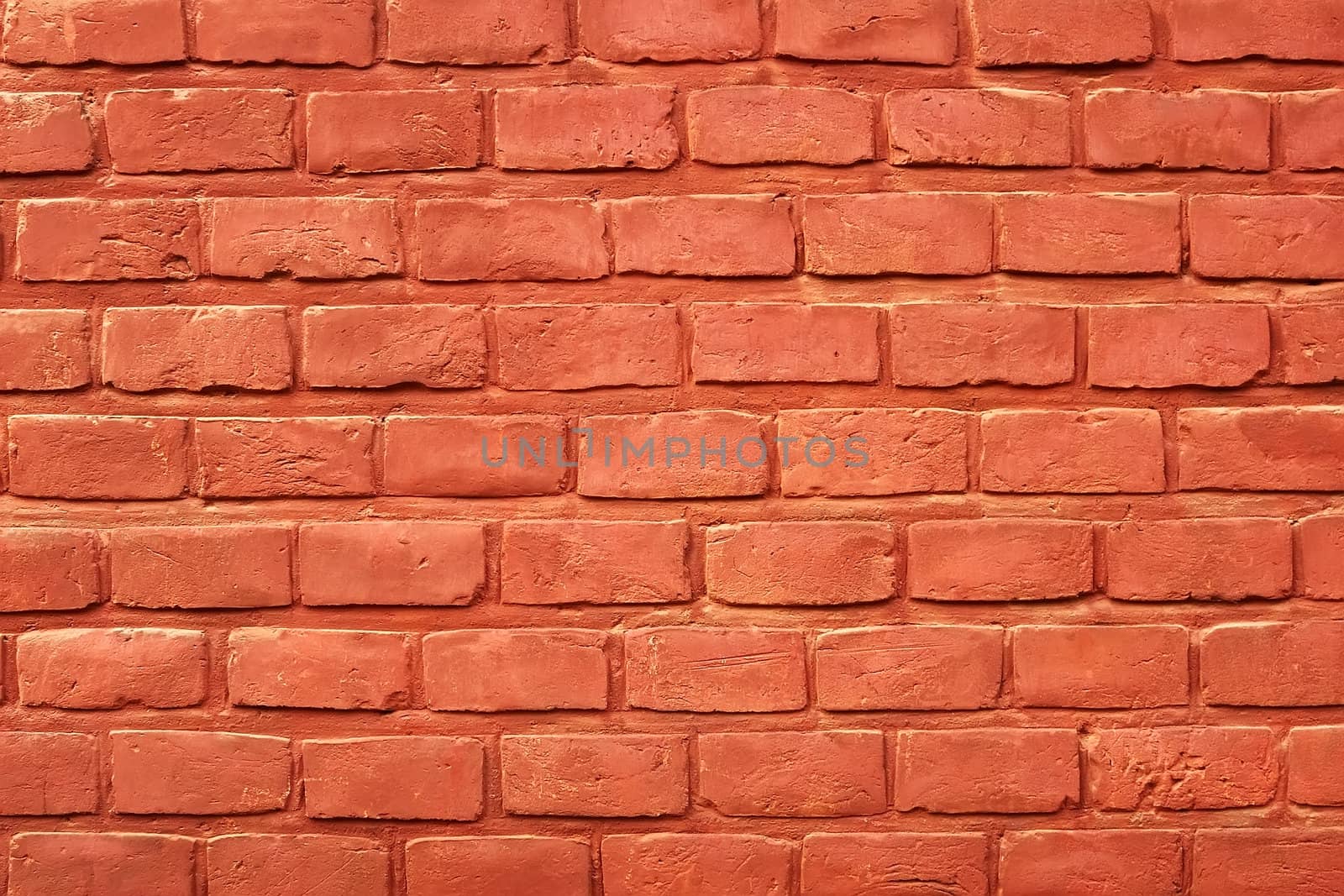 Ancient brick wall painted with red paint