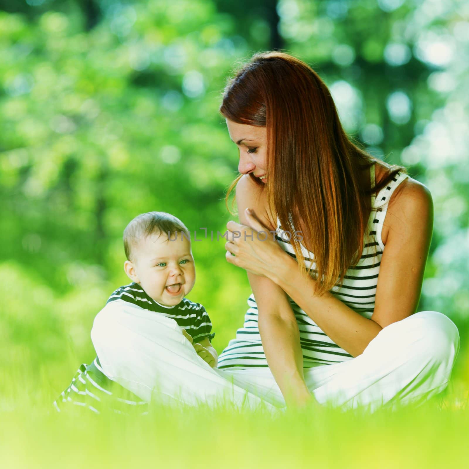 Happy mother and daughter on grass