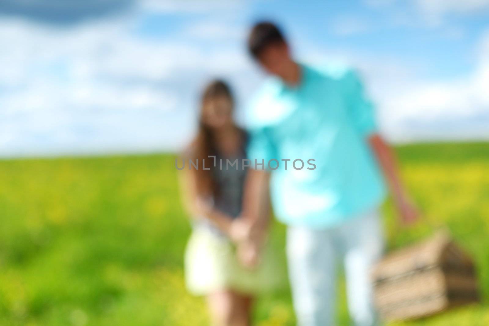 man and woman walk on picnicdesfocused