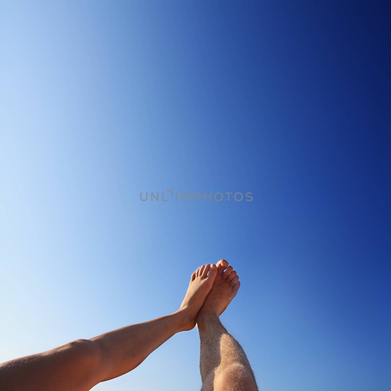 beautiful feet of man and woman in the summer by photochecker