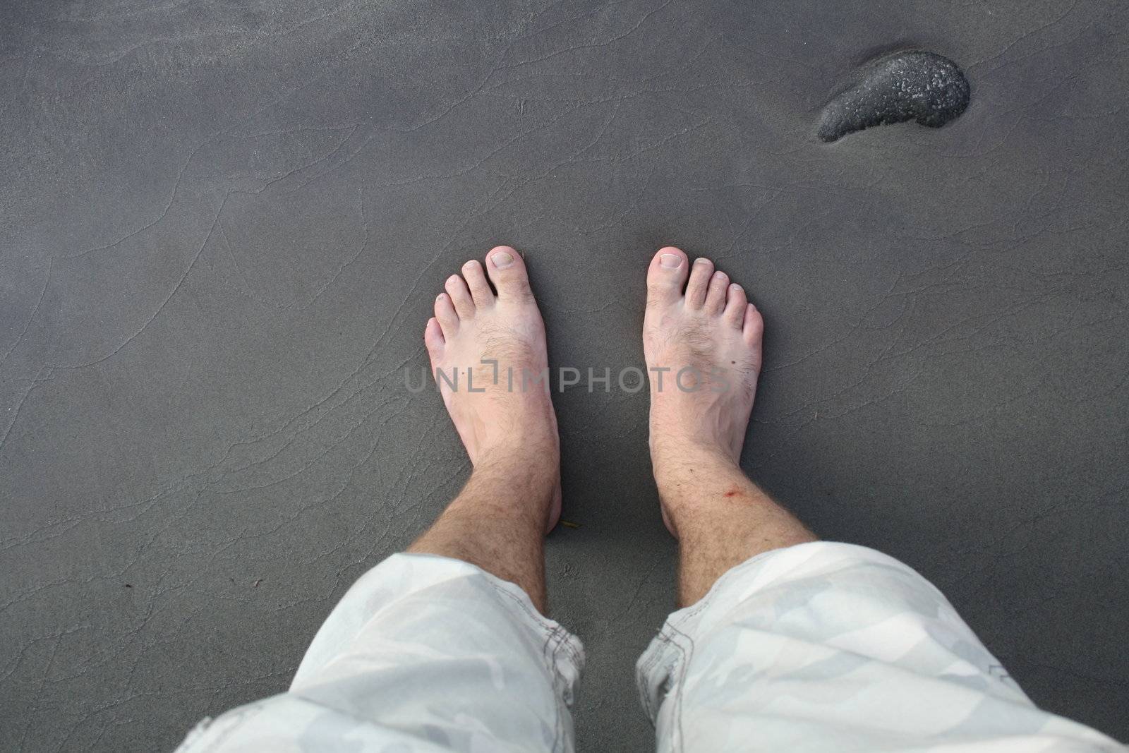 barefoot man on sea beach