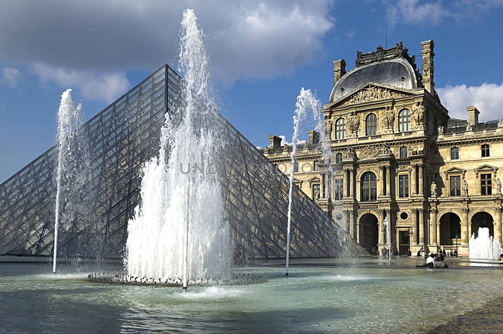 Glass Pyramid and the fountain at the Louvre Museum by irisphoto4