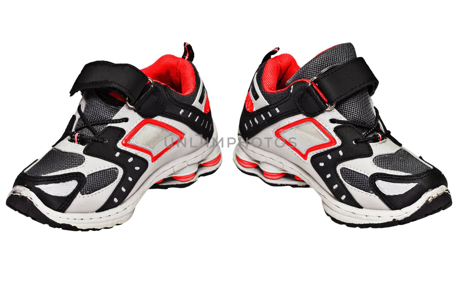 Youth sneakers with red elements isolated on white background