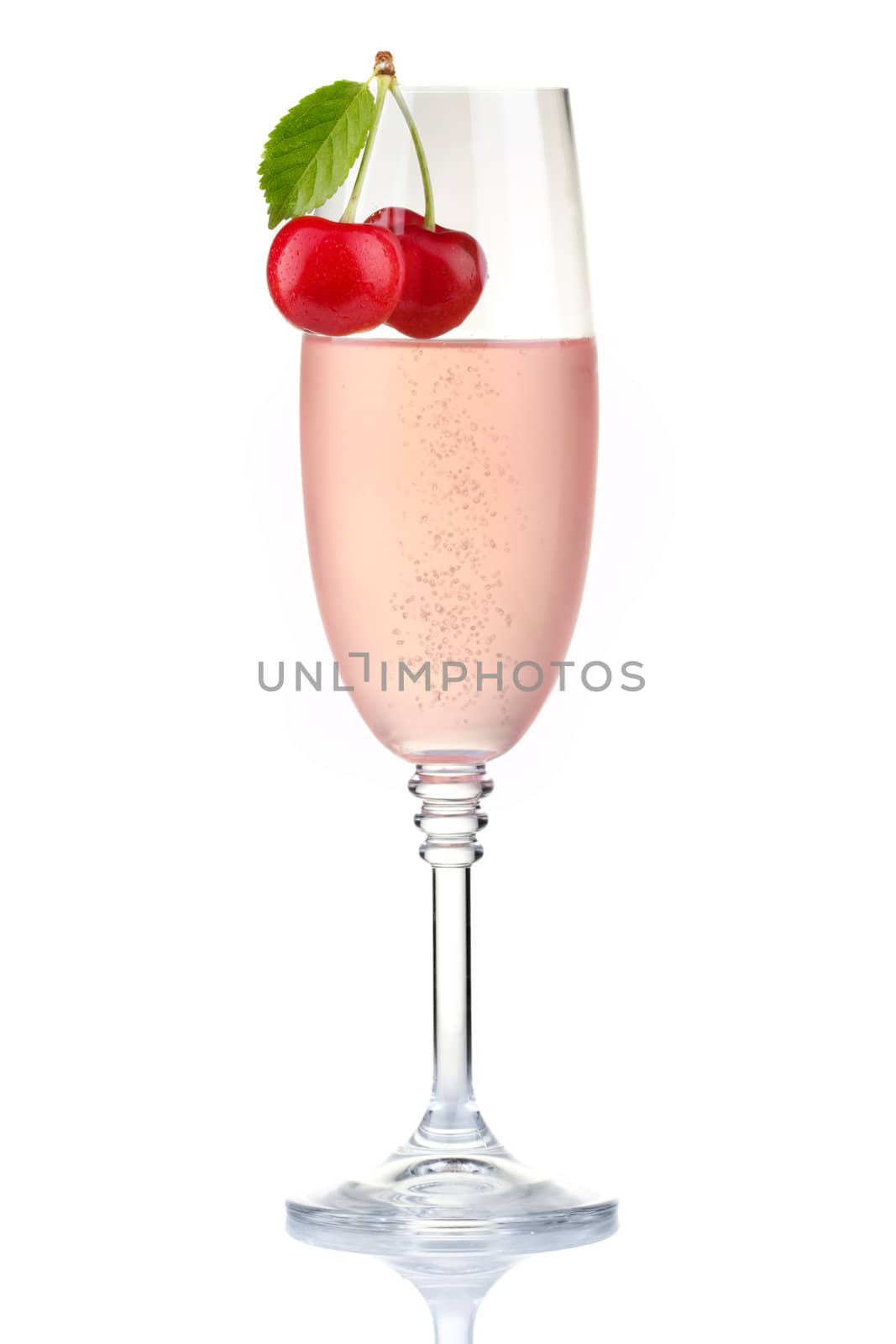 Glass of pink champagne with fresh cherry berries isolated on white background