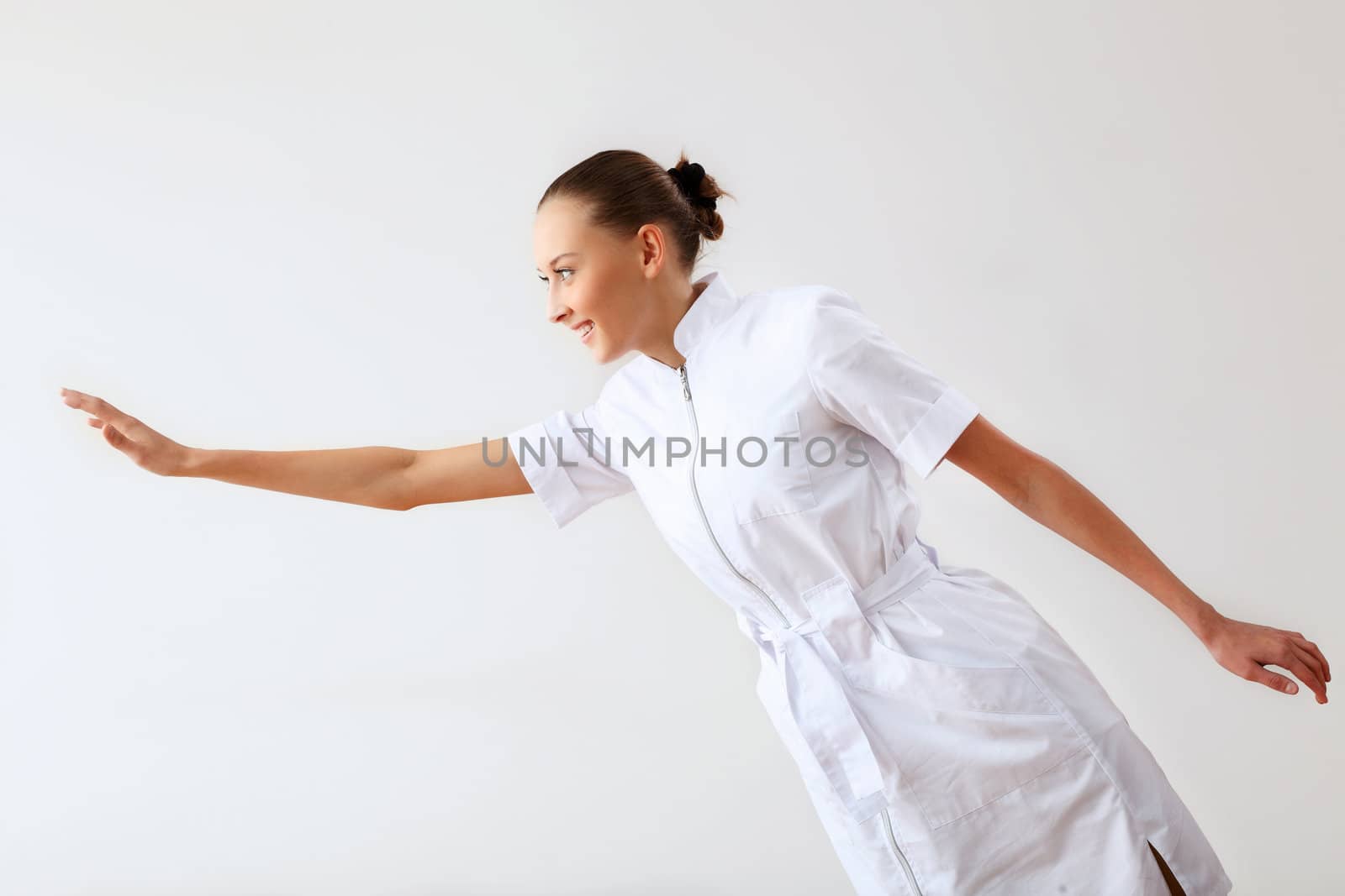 Young female doctor in white uniform at workplace