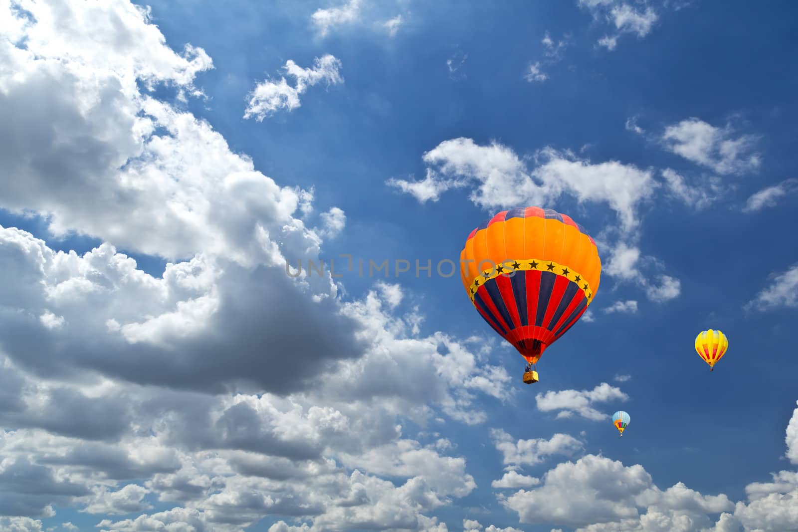 Colorful hot air balloons against blue sky by tungphoto