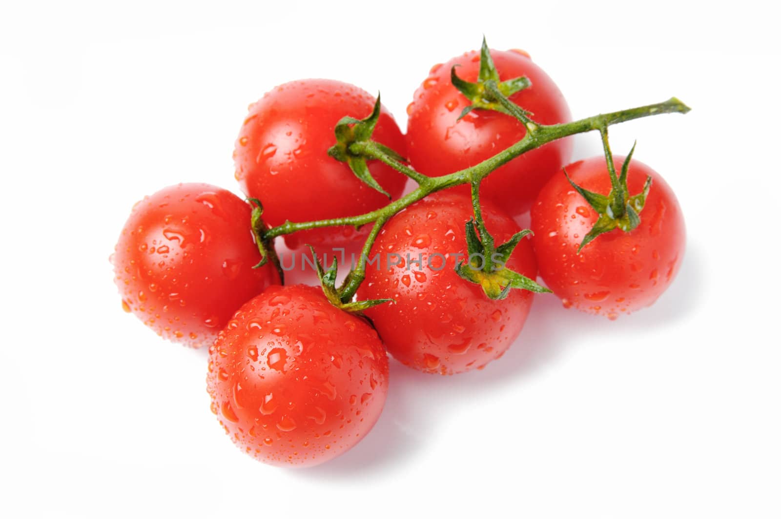 An image of red tomatoes with drops of water on them