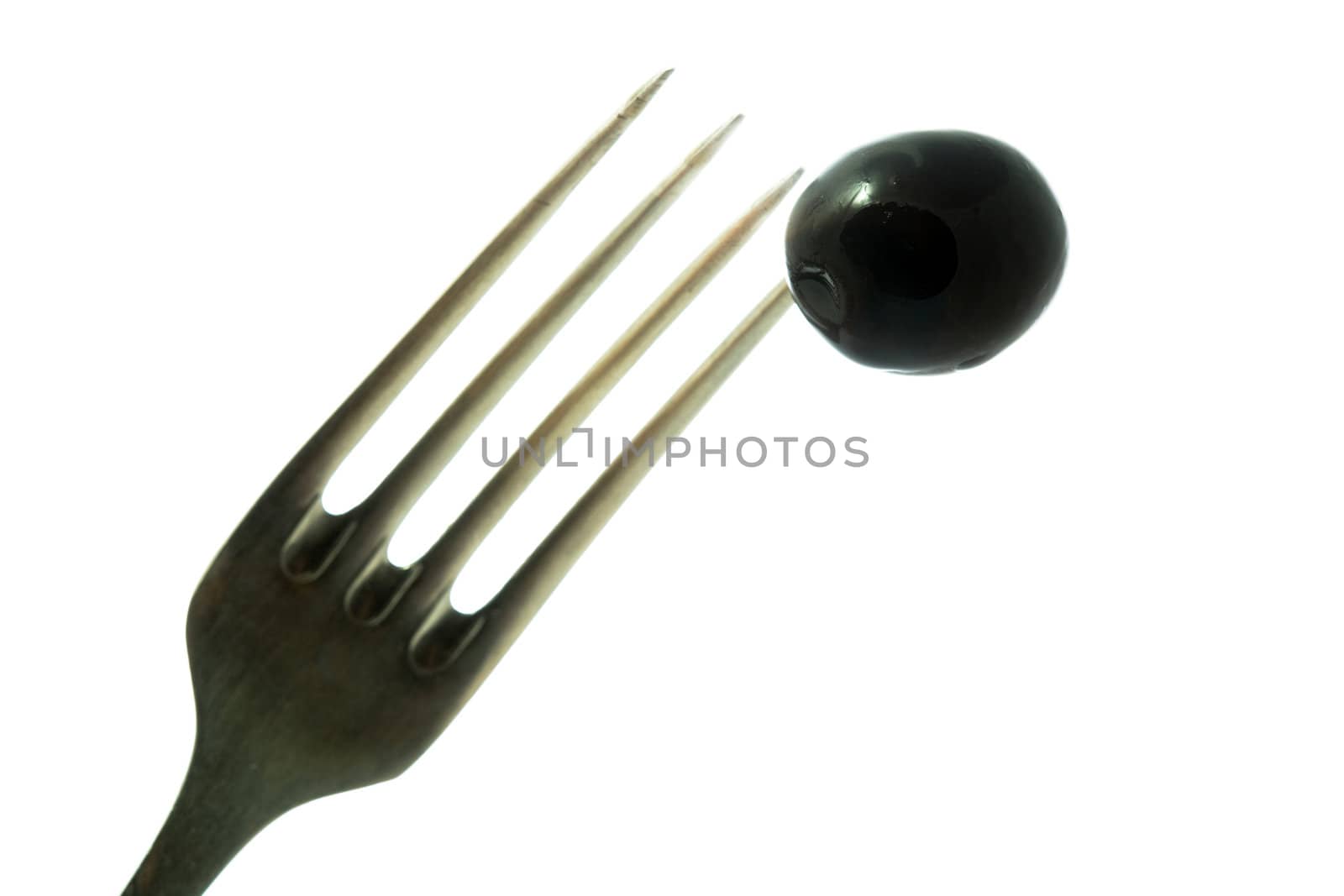 Stock photo: an image of black olive on the fork