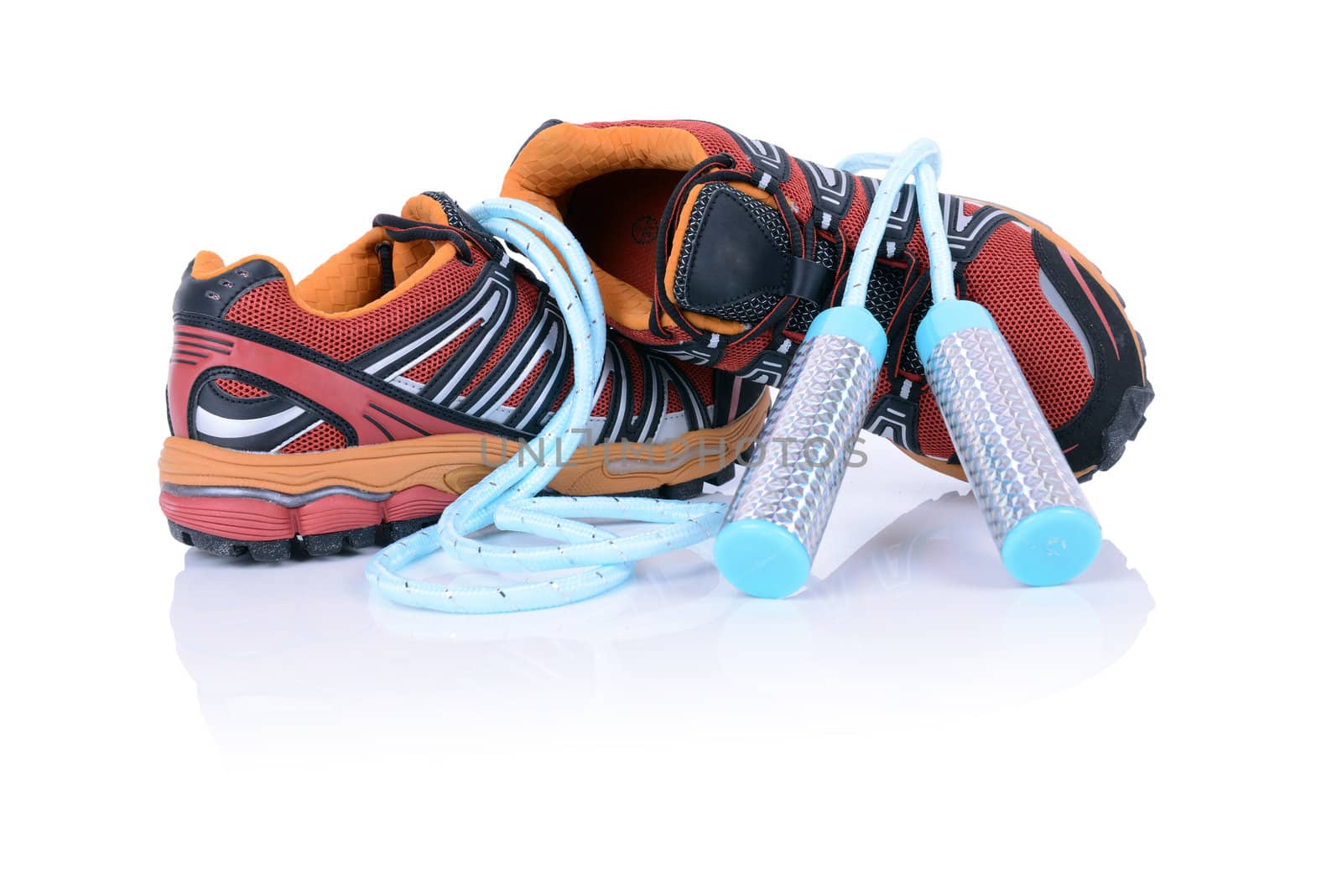 concept for exercise running shoes and skippingrope isolated on white