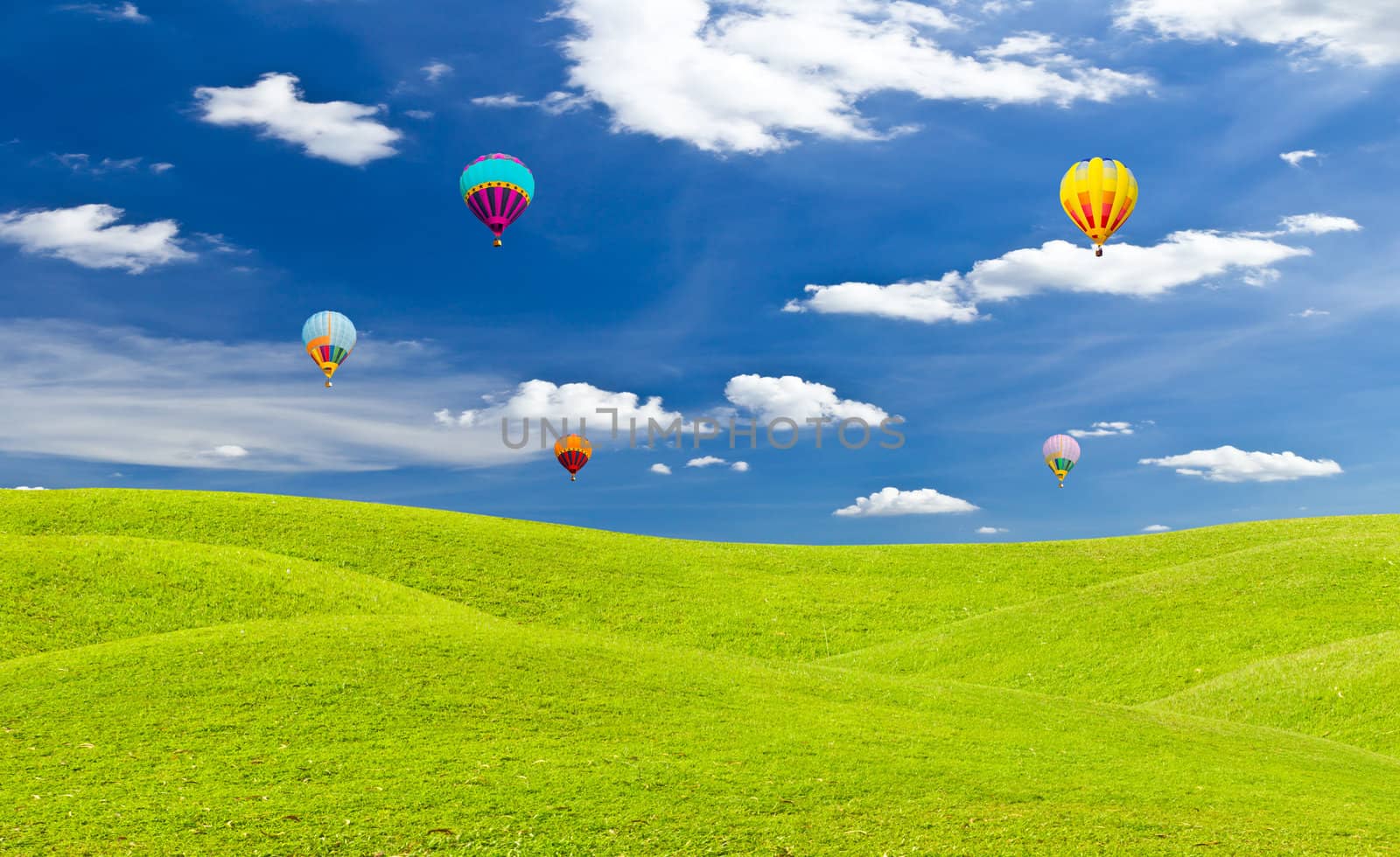 colorful hot air balloon against blue sky by tungphoto