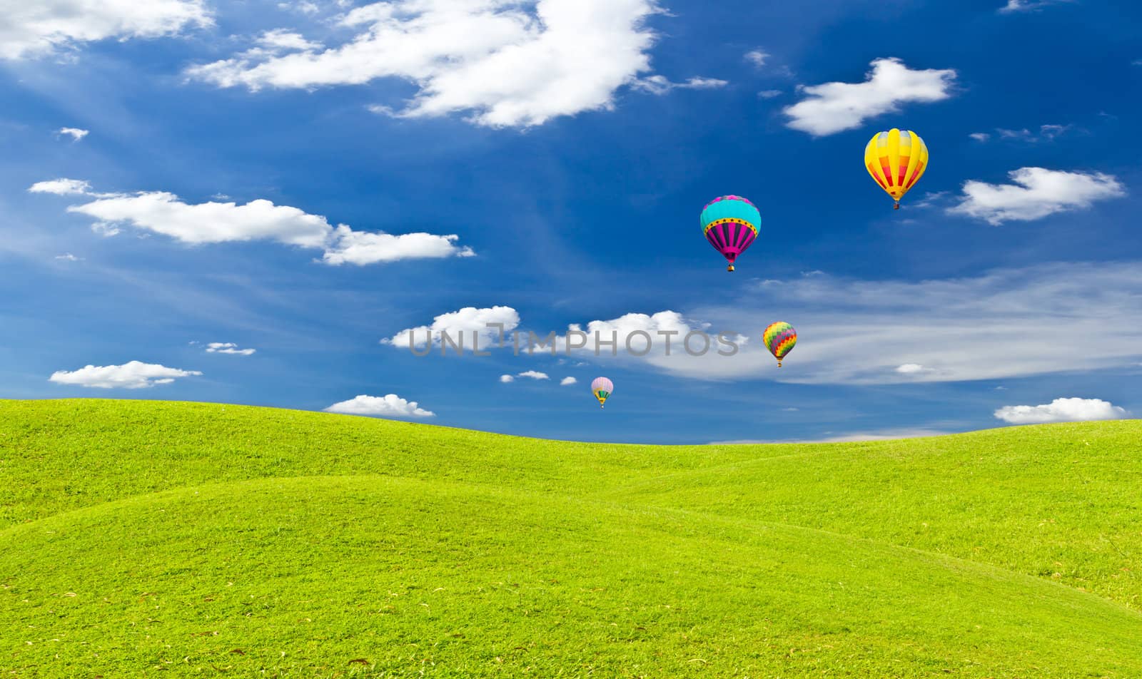 colorful hot air balloon against blue sky by tungphoto