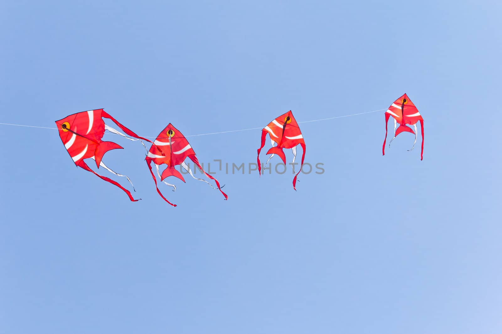 Fish kite against blue sky by tungphoto