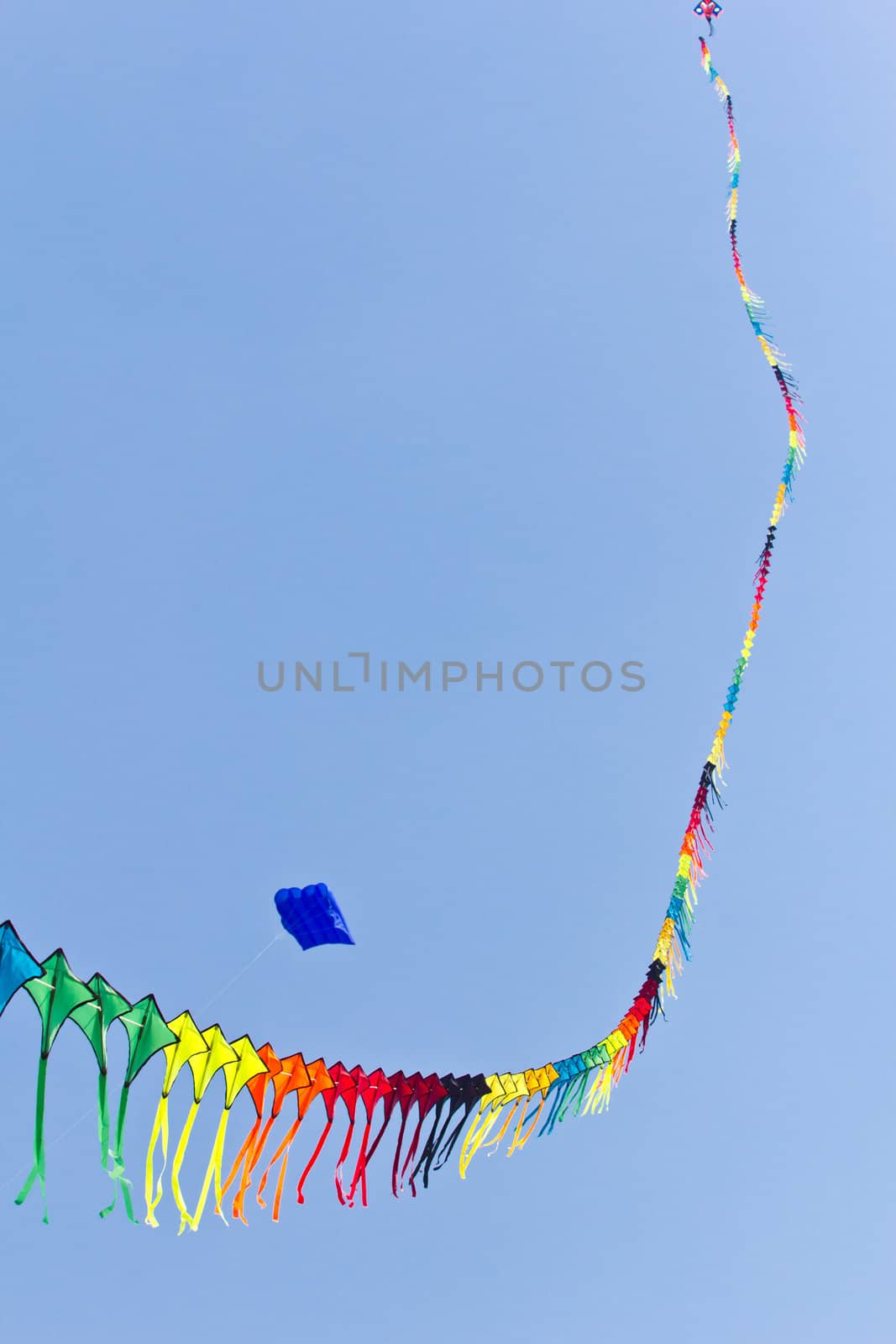 colorful of kite against blue sky by tungphoto