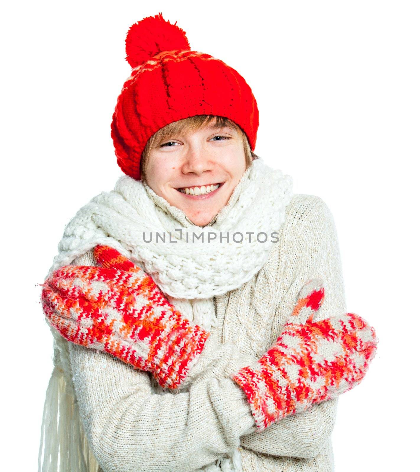 Portrait of young smiling cute frozen teenager in a red hat and mittens, isolated on white