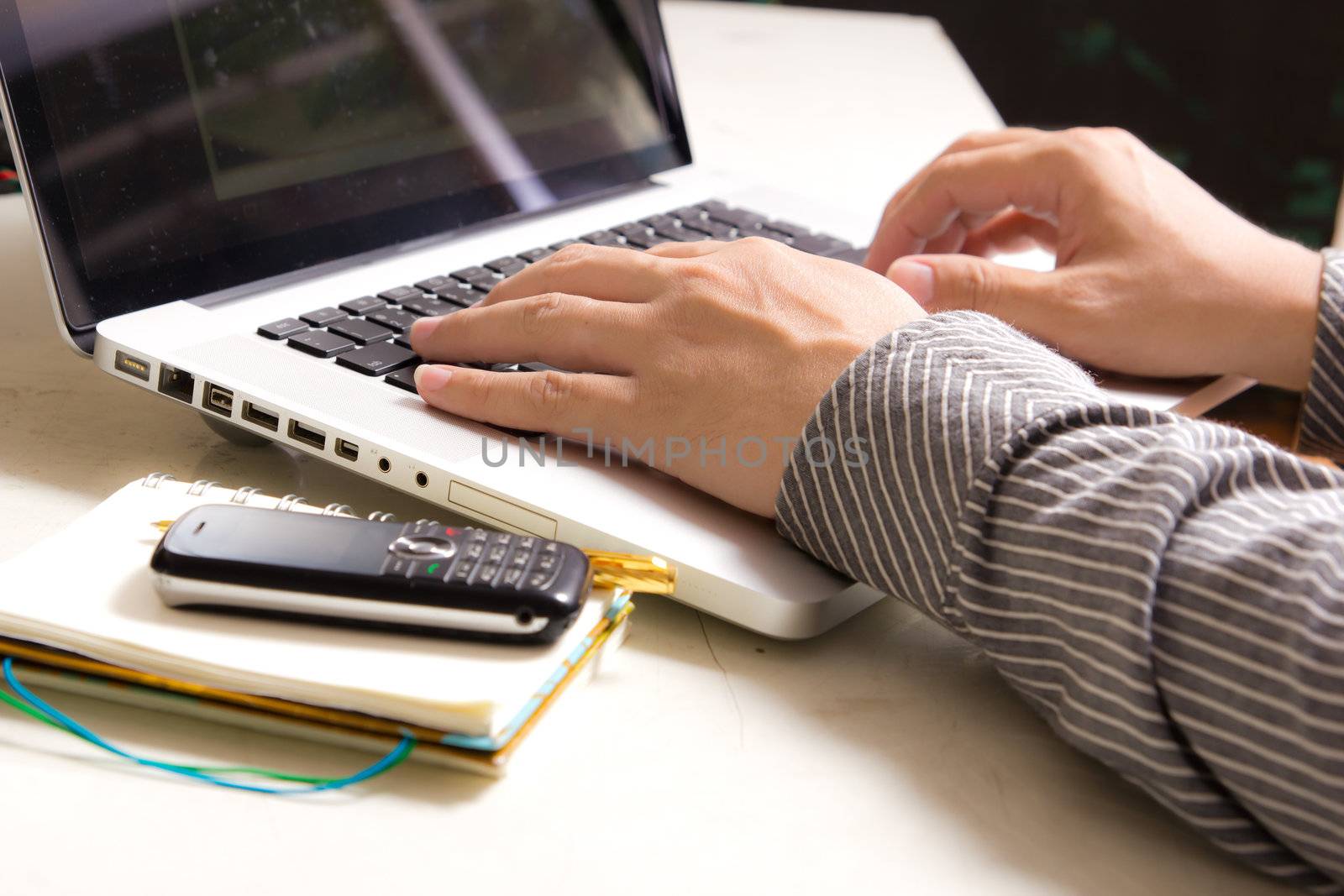 hands of Business man typing on notebook by tungphoto