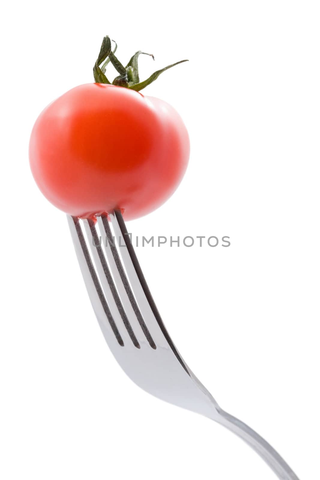 ripe tomato on fork isolated
