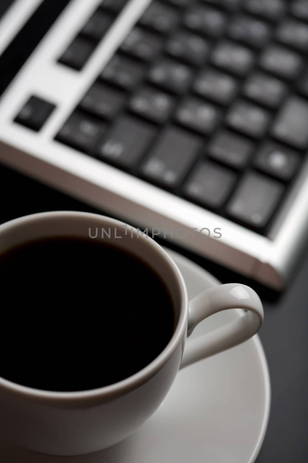 cup of coffee and keyboard (shallow DOF)
