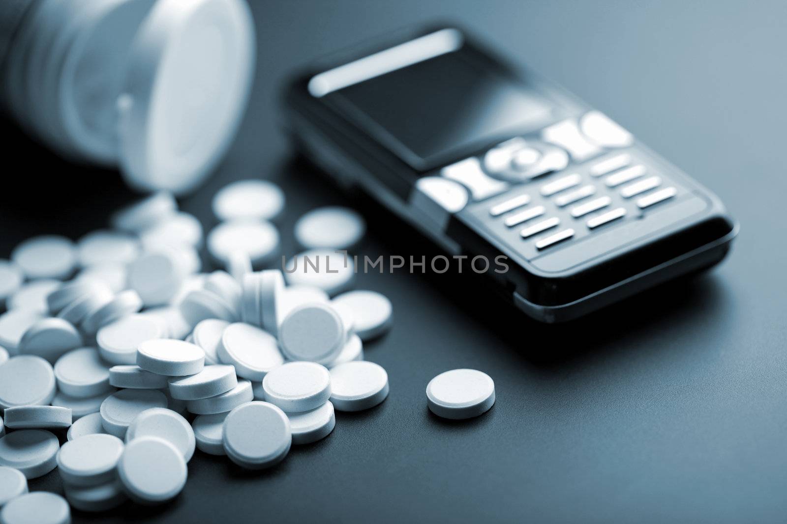 calling for medical help: white pills and mobile phone