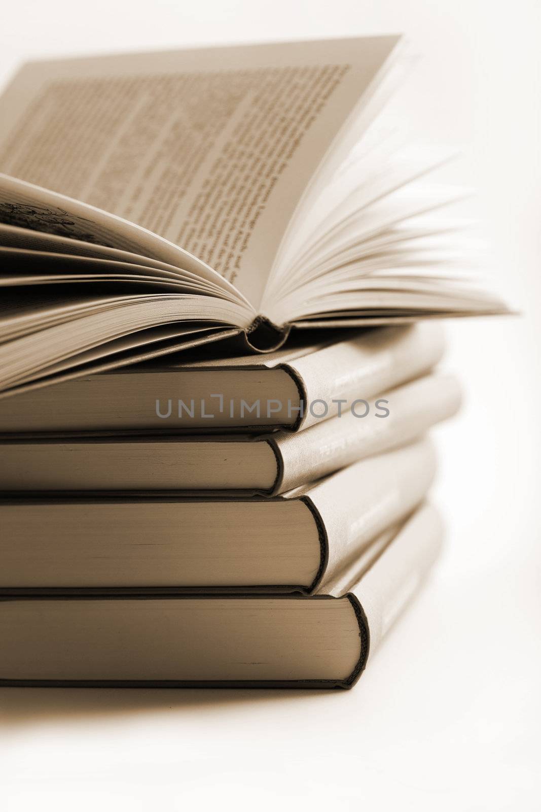 pile of books with one book open
