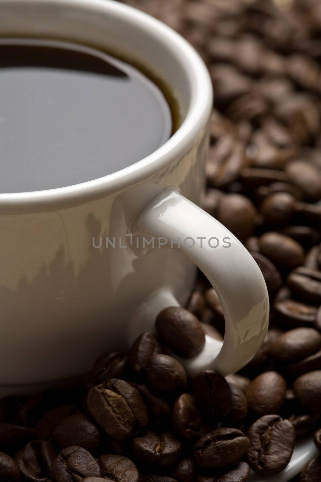 white cup of coffee and coffee beans
