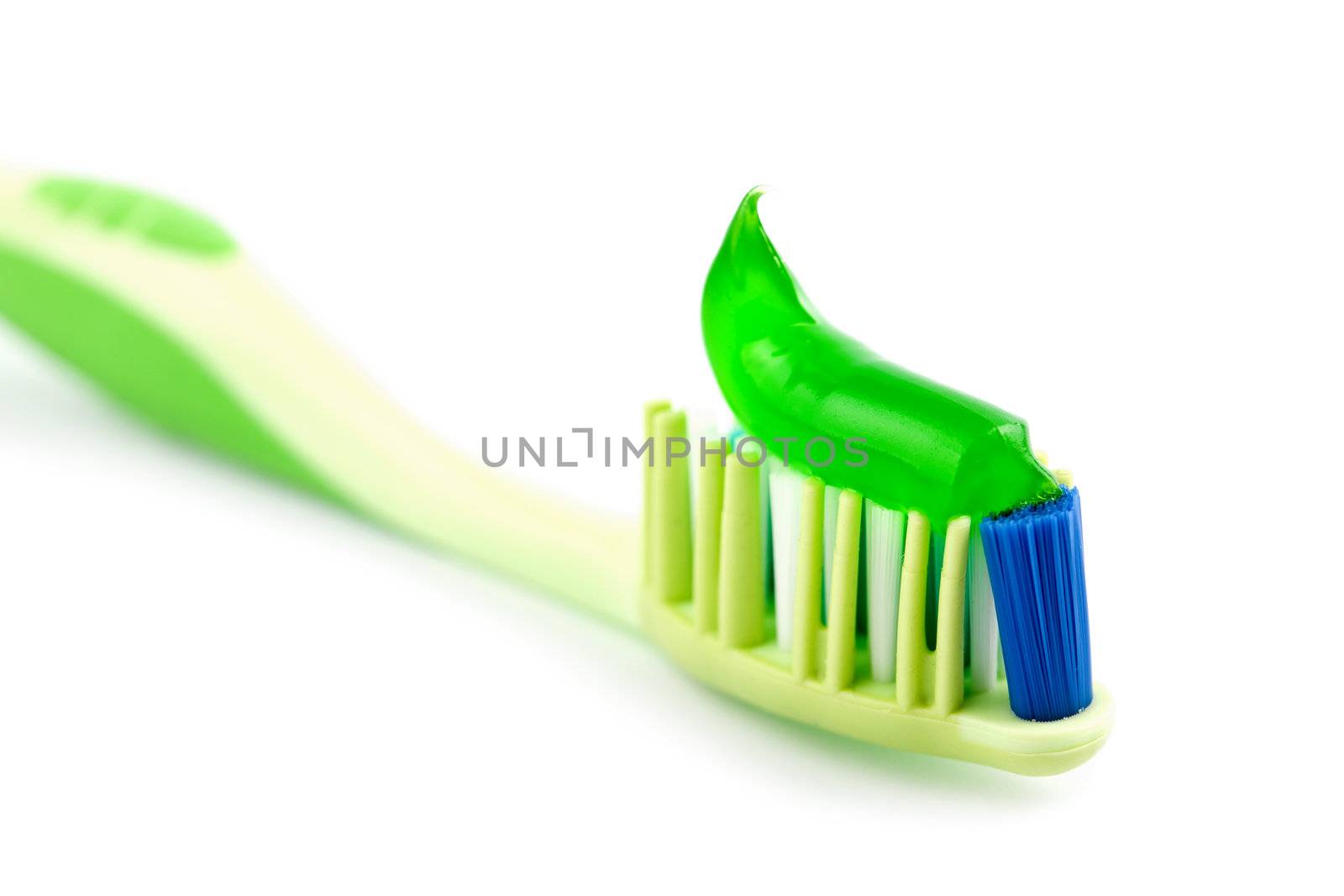toothbrush with green toothpaste isolated by duskbabe