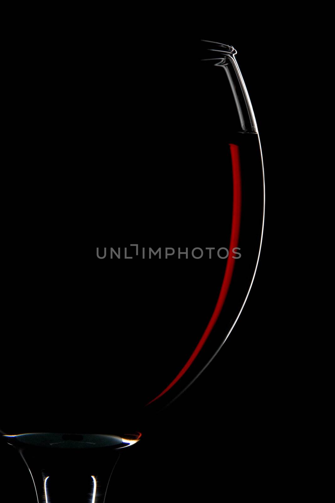 half of red wine glass isolated on black