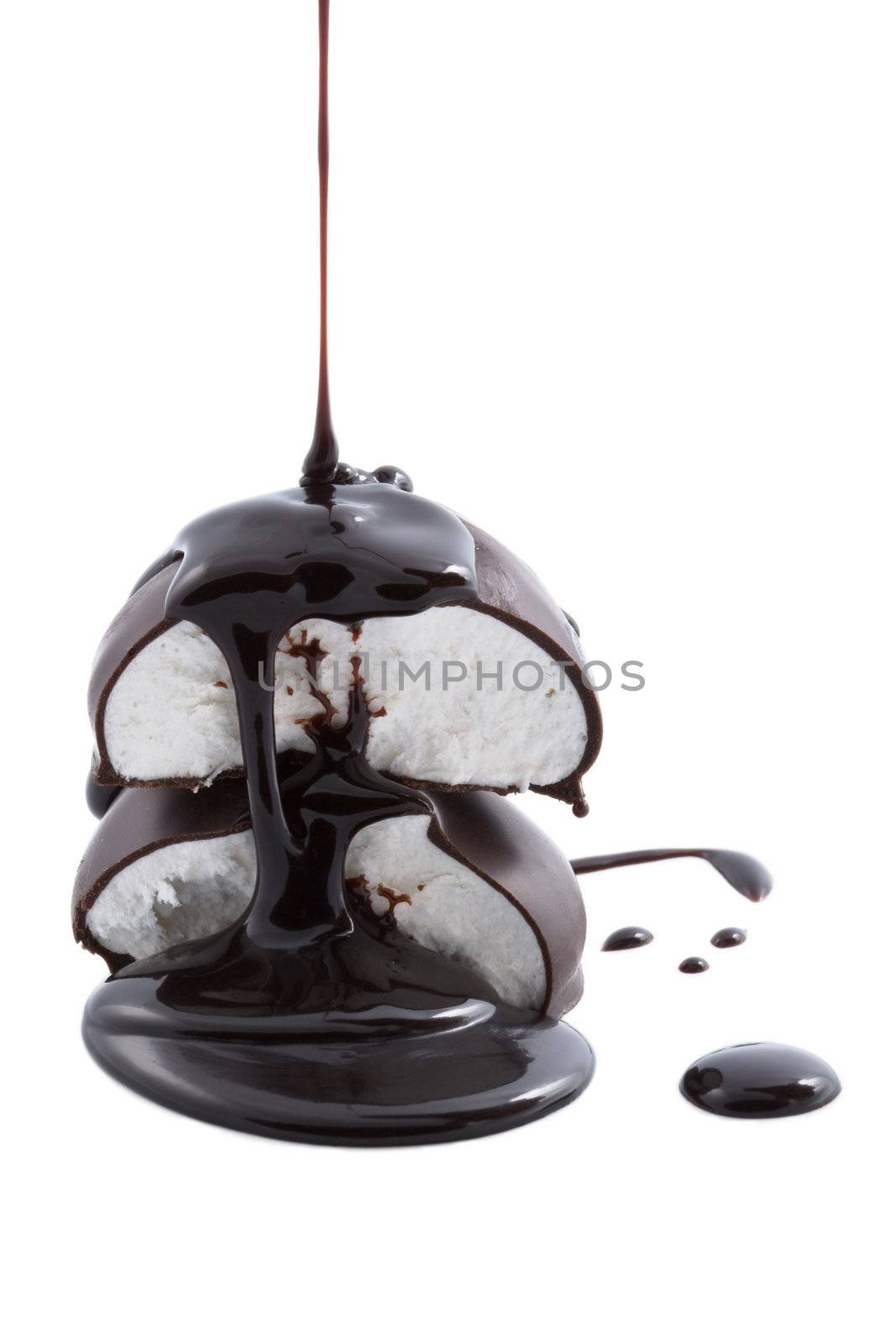 chocolate syrup being poured onto marshmallows