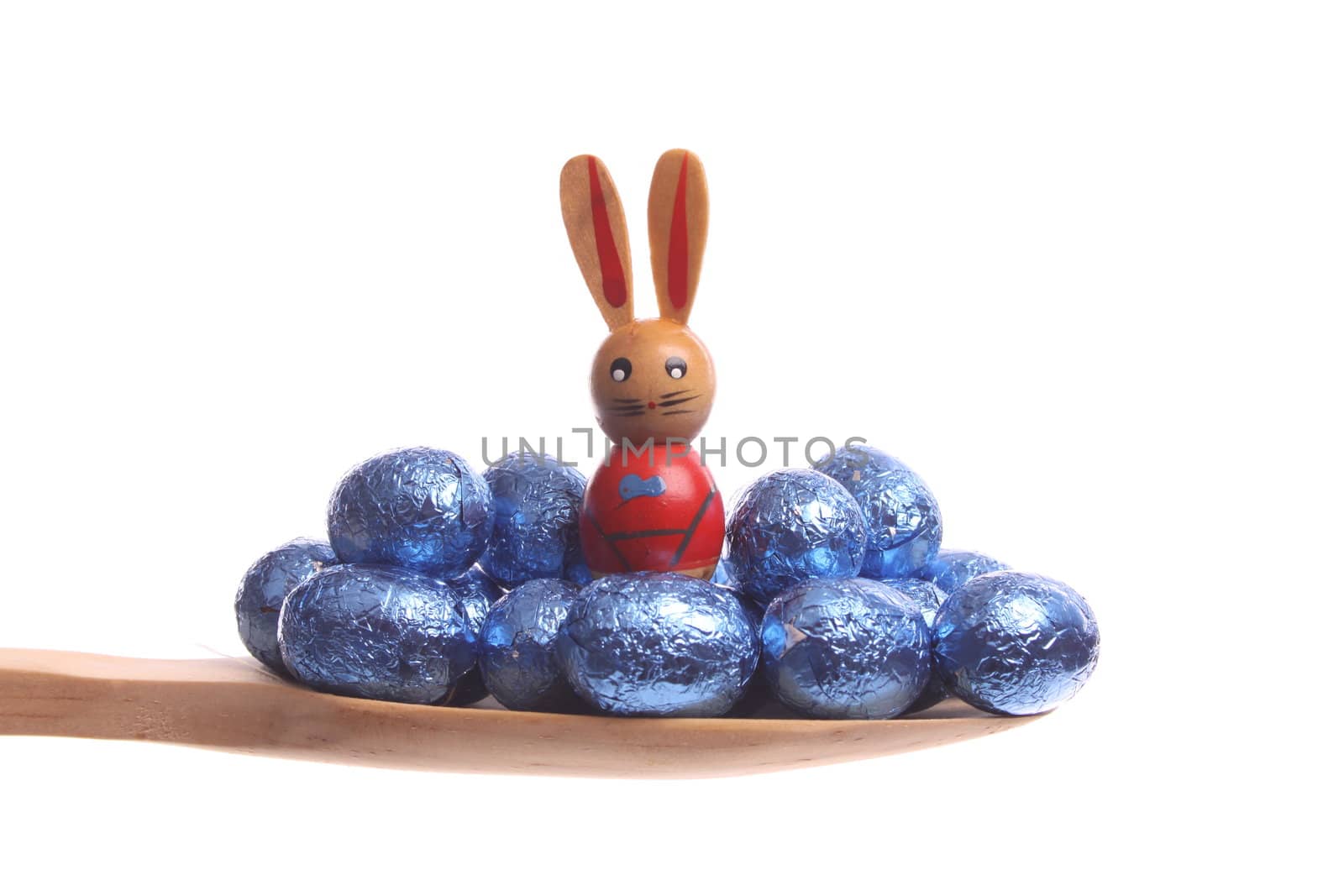 Easter eggs simply offered on a wooden spoon isolated on a white background 