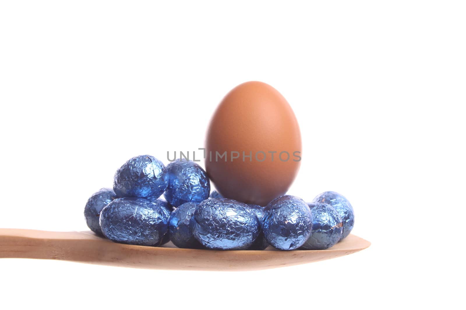 Easter eggs simply offered on a wooden spoon isolated on a white background 