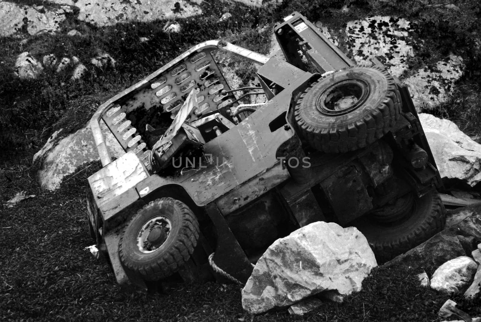 An overturned agriculture vehicle.