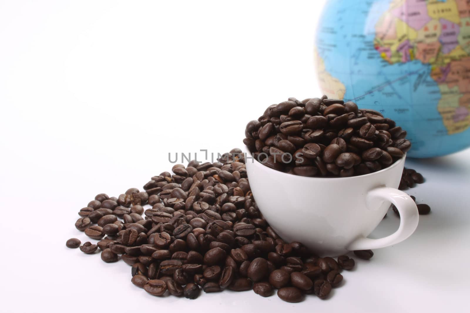Roasted coffee beans  and a coffee cup and a globe