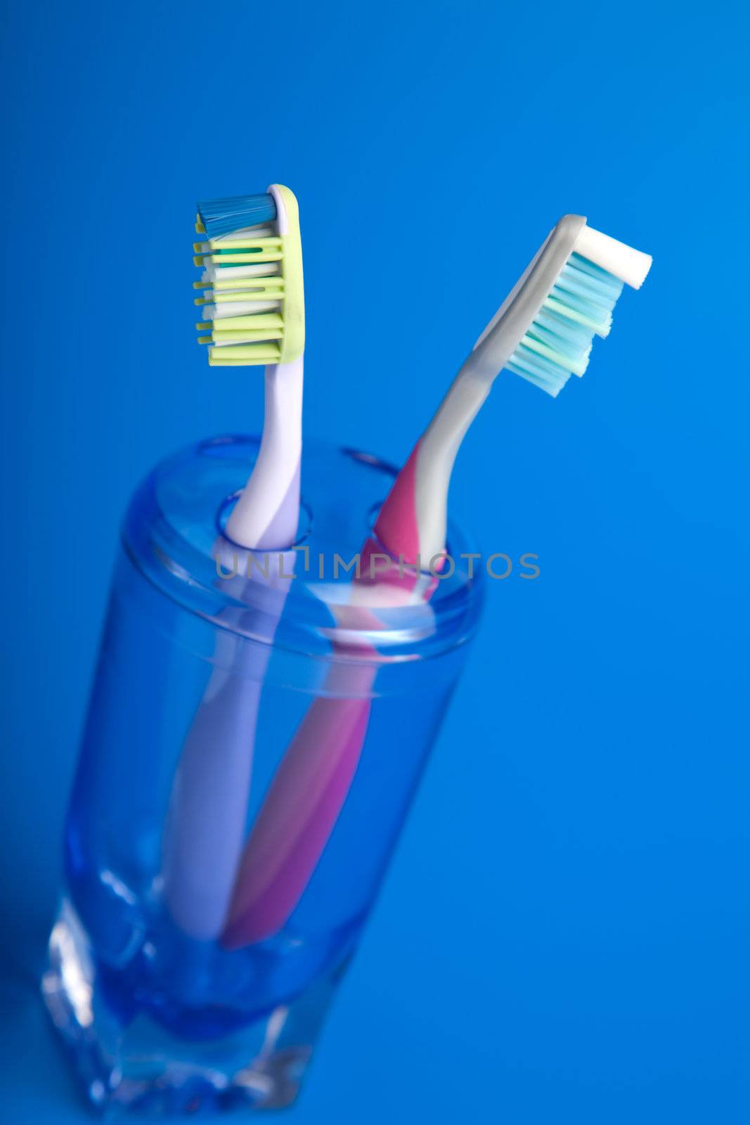 two colorful toothbrushes by duskbabe