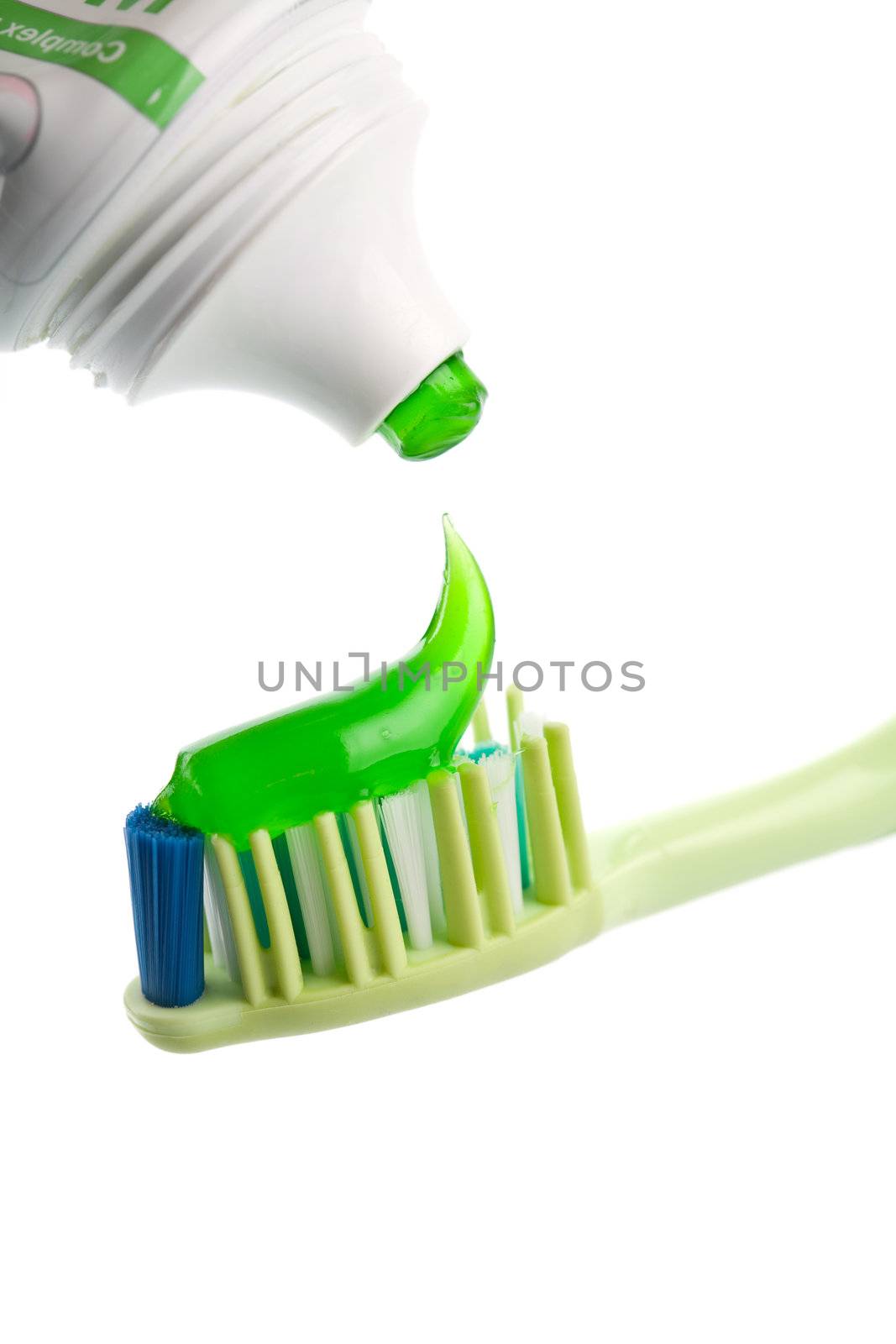 toothbrush, green toothpaste and tube isolated by duskbabe