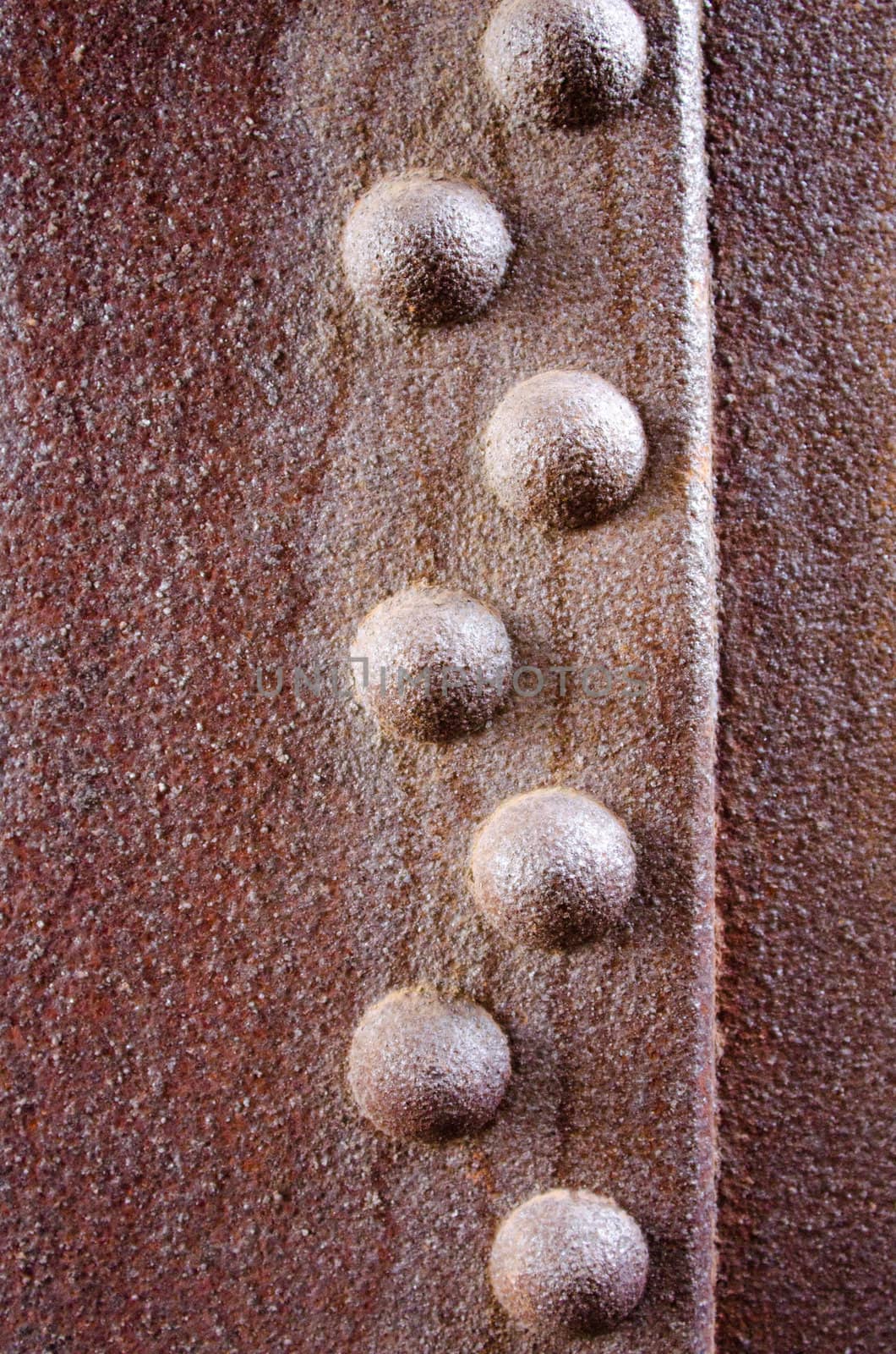 rivets on a rusty metal sheet