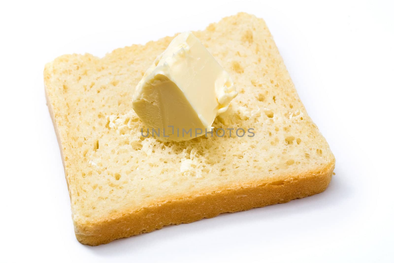 Stock photo: an image of yellow butter on a slice of bread
