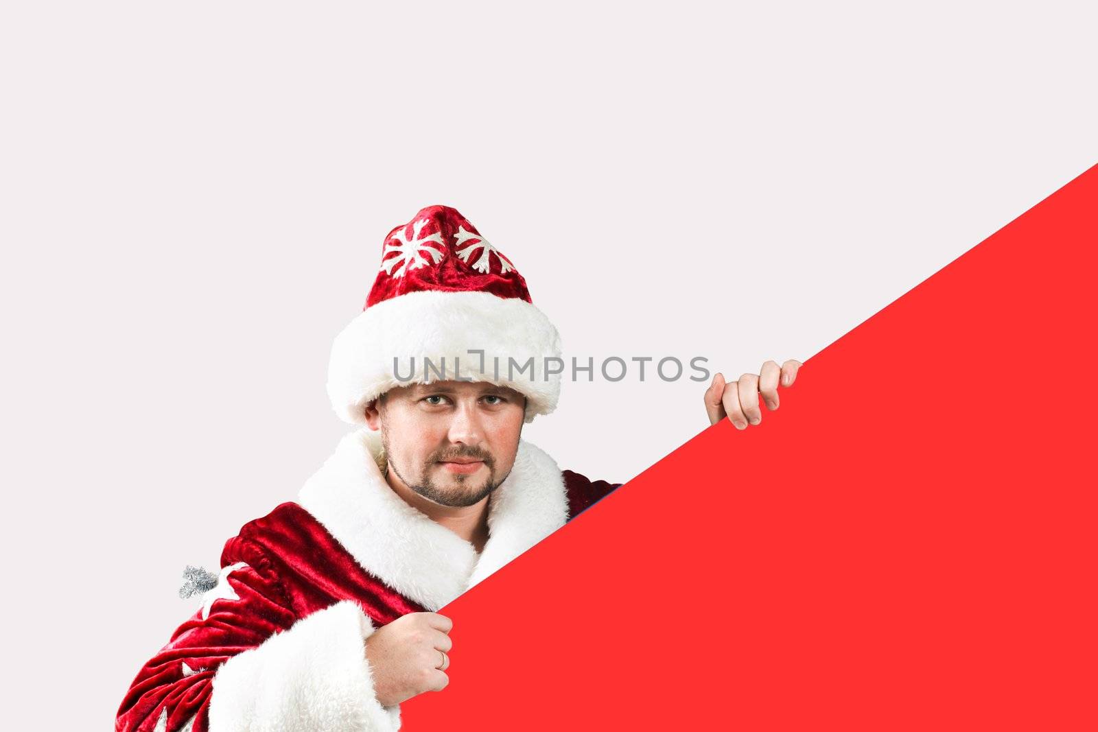 Male caucasian model of santa claus holding a red board