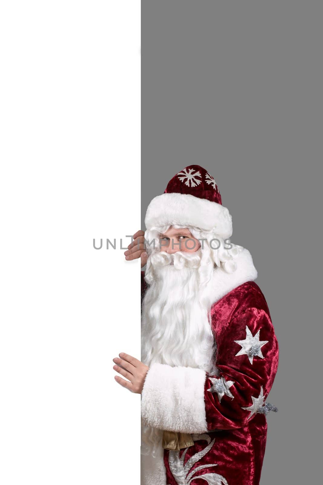 Santa Claus carrying a page of white paper