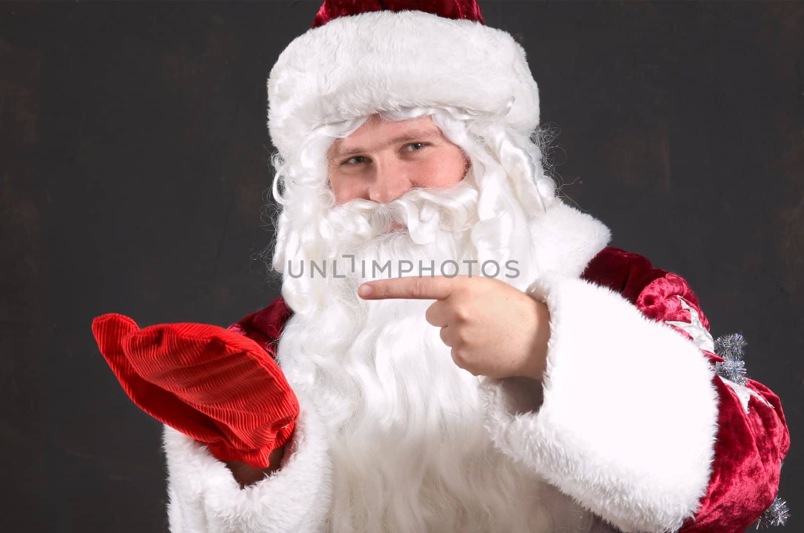 Santa Claus showing onto a red mitten