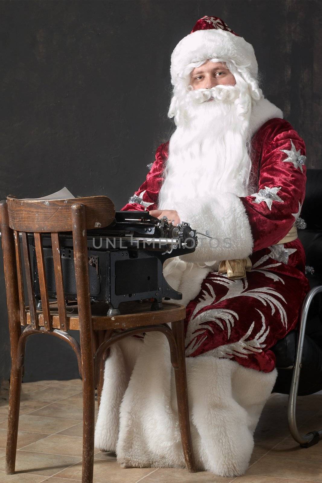 Santa Claus typing a letter on an typewriter