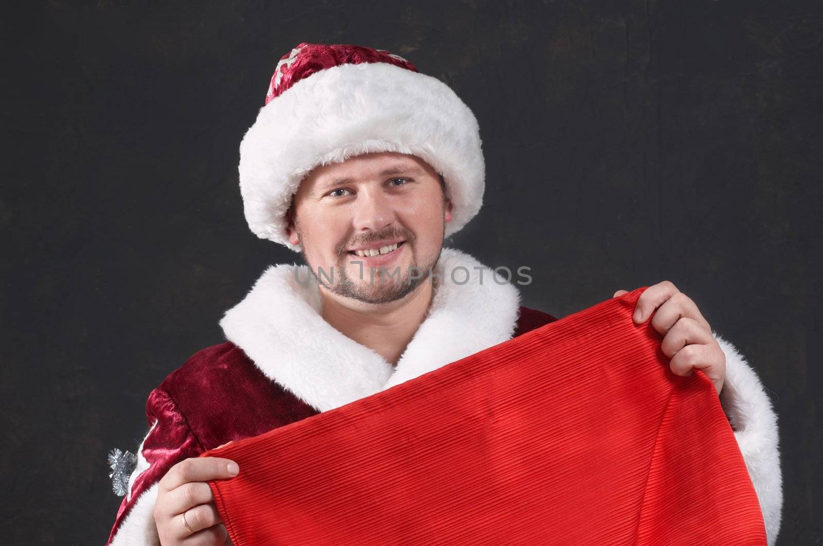 An image of smiling Santa with bag
