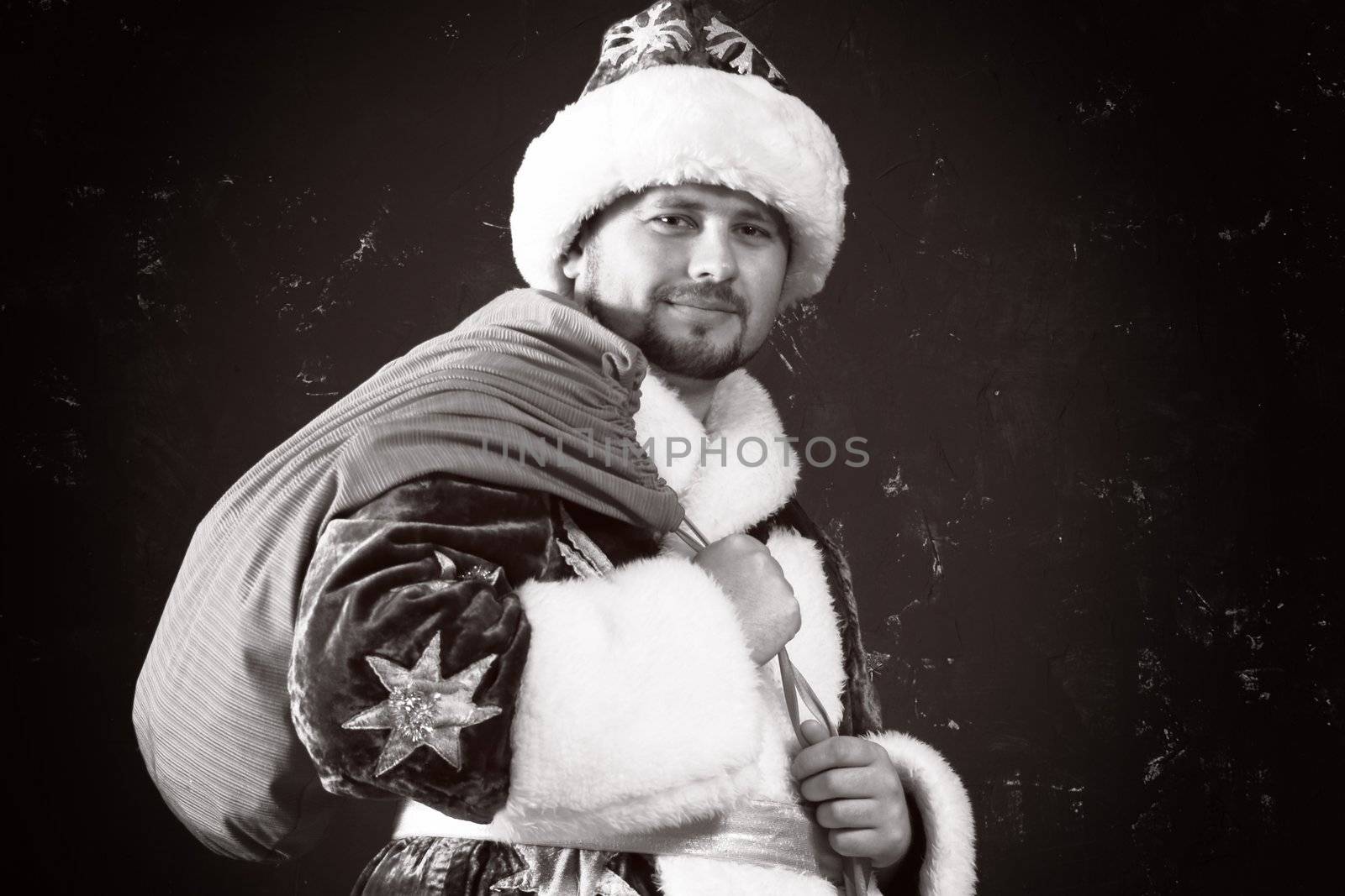 Santa Claus carrying a bag with gifts