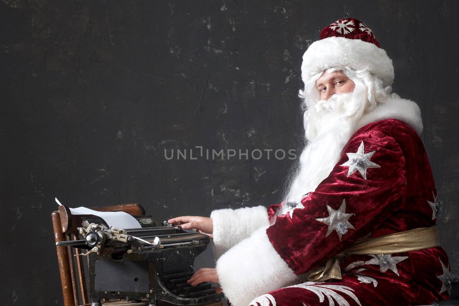 Santa Claus typing a letter on an old typewriter