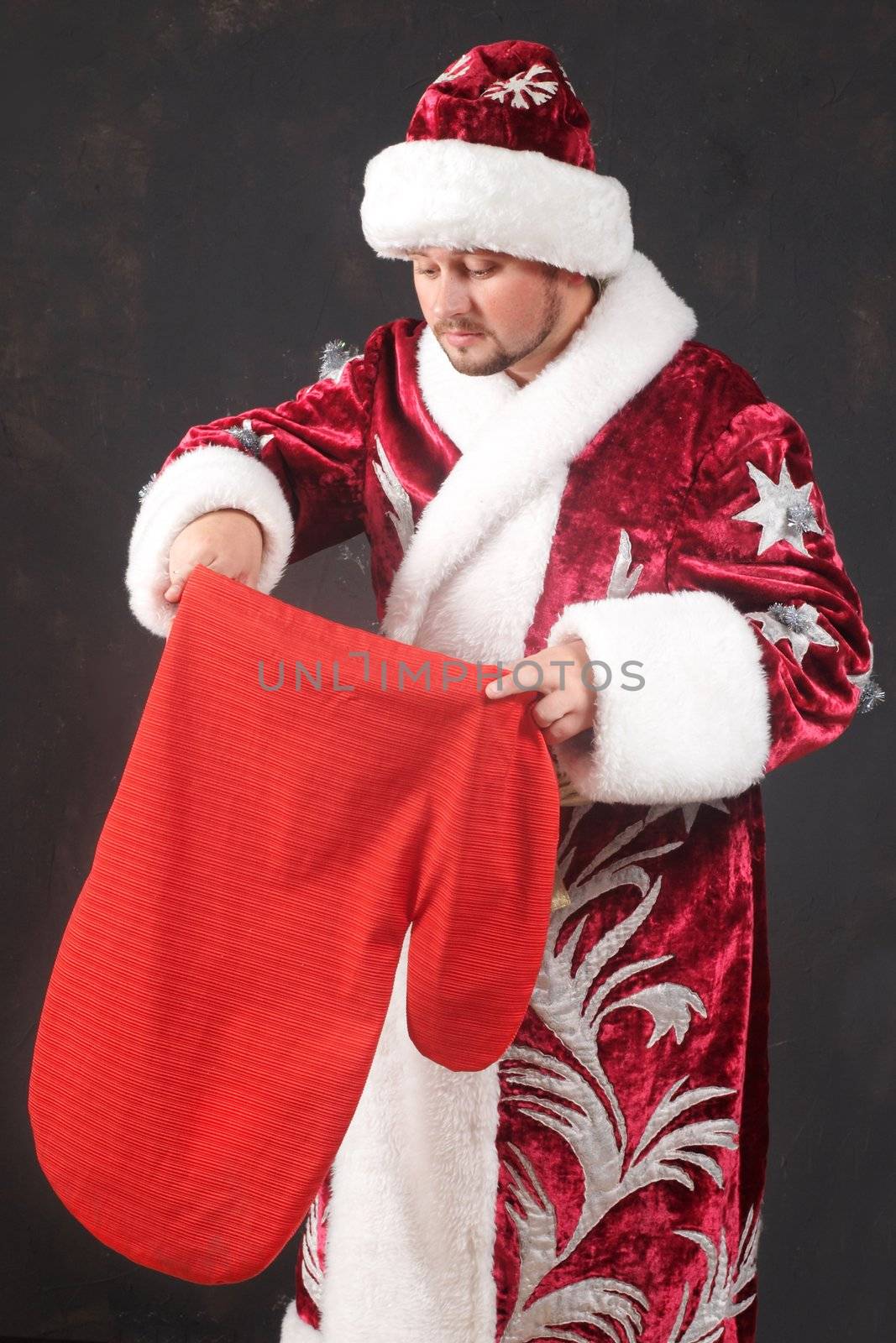 Santa Claus carrying a red bag with gifts