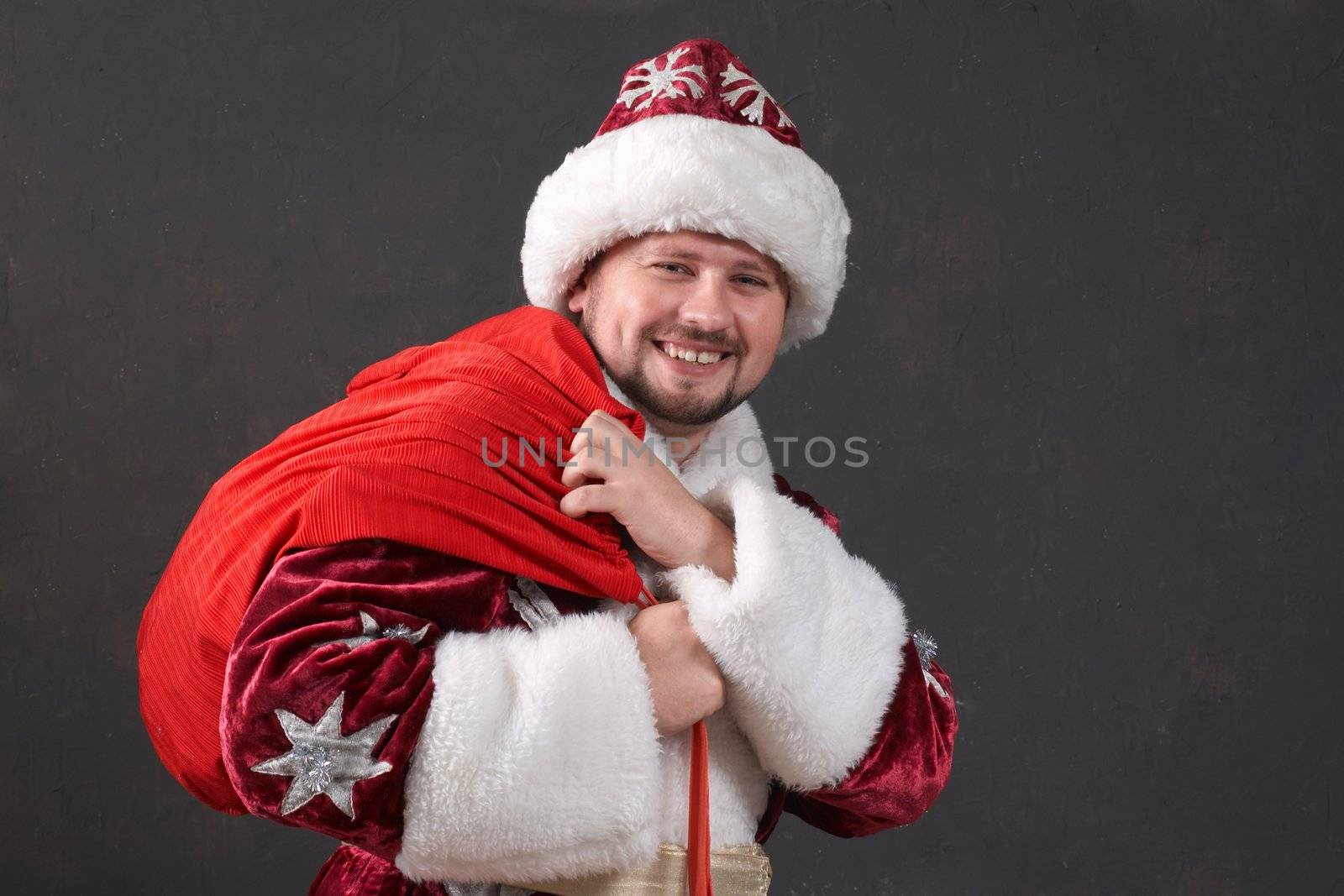 Santa Claus carrying a bag with gifts