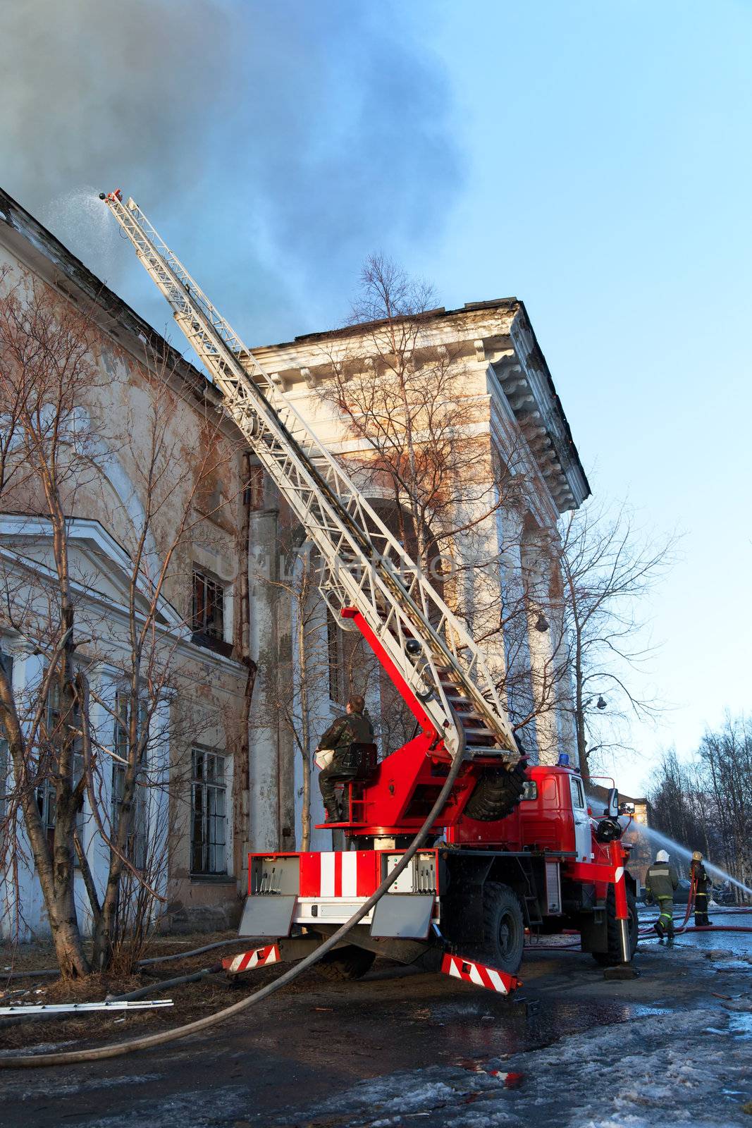 Russia. Kandalaksha. April 2013. Firefighters extinguish a burning palace of culture