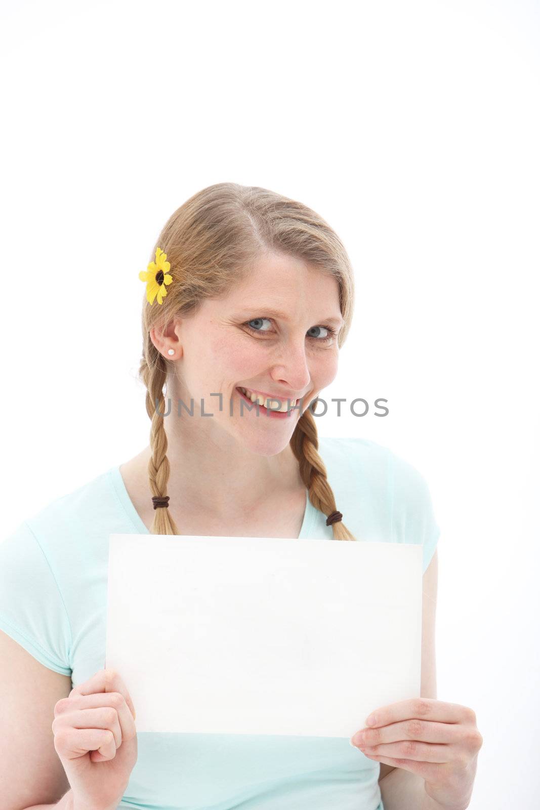 Pretty blonde with braids and a yellow daisy in her hair, holding up a blank sheet of paper