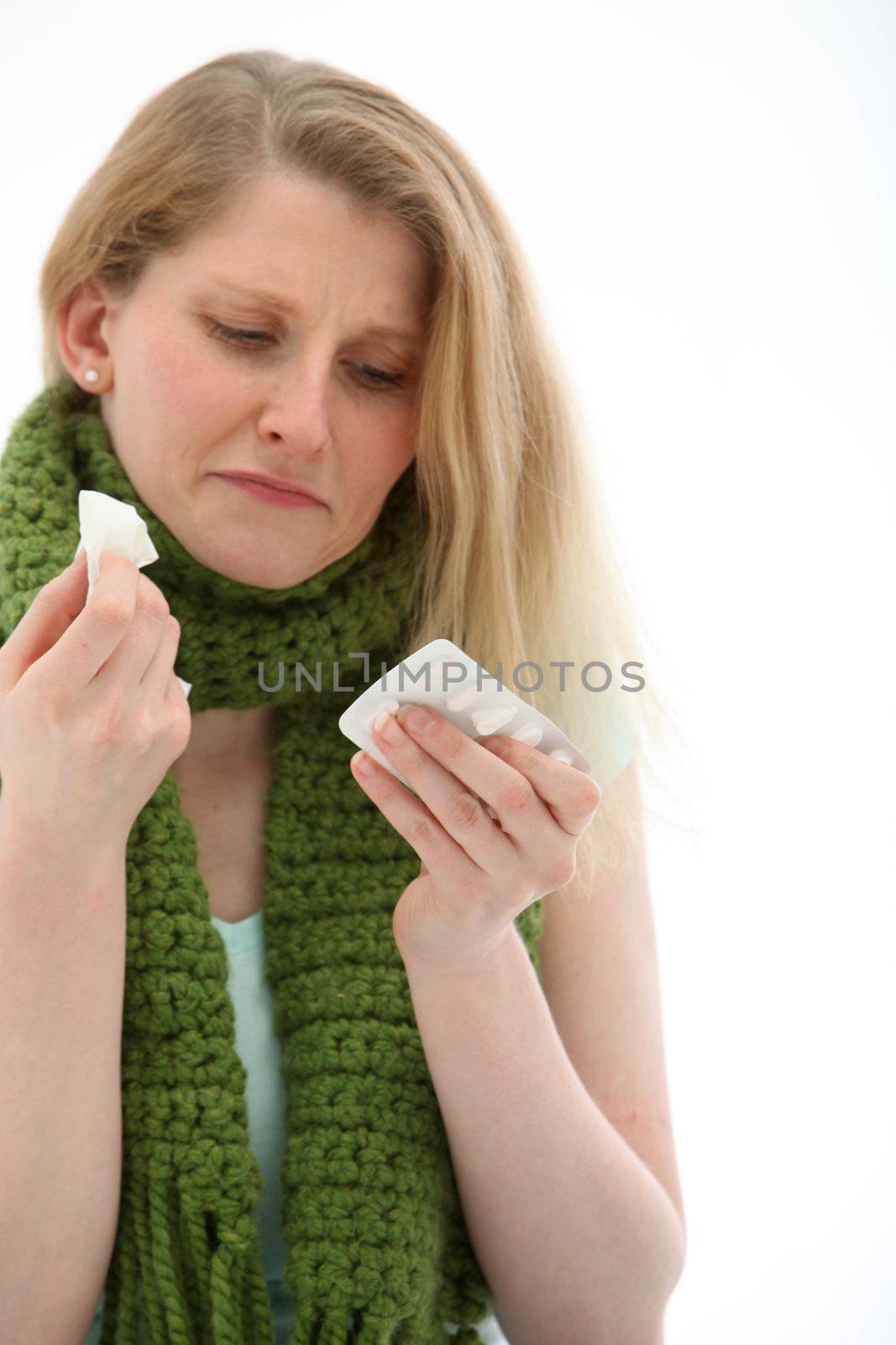 Young girl with a warm scarf around her neck to stay warm is feeling the misery of a bad head cold